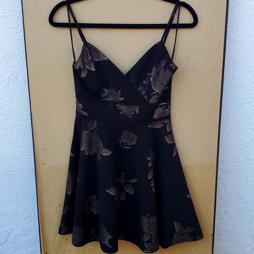 I am selling a small black and gold dress from miami!